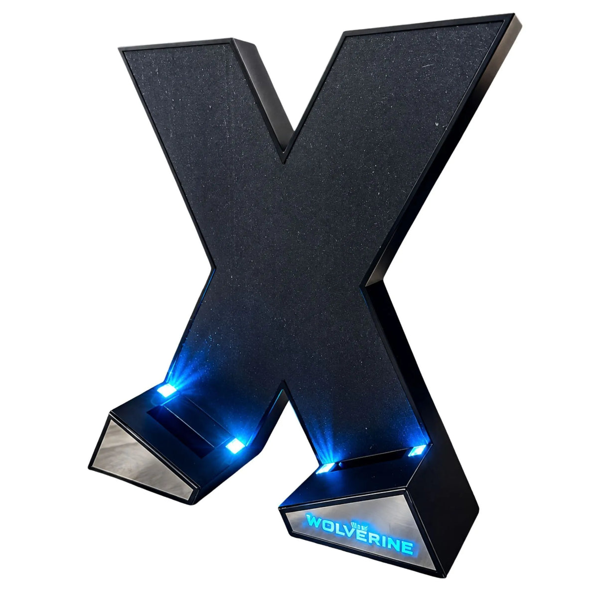 A large 3D letter 'X' lamp or sign with a textured black finish, featuring integrated blue LED lights on the base and the word 'WOLVERINE' illuminated on the lower right panel, shown on a plain white background.