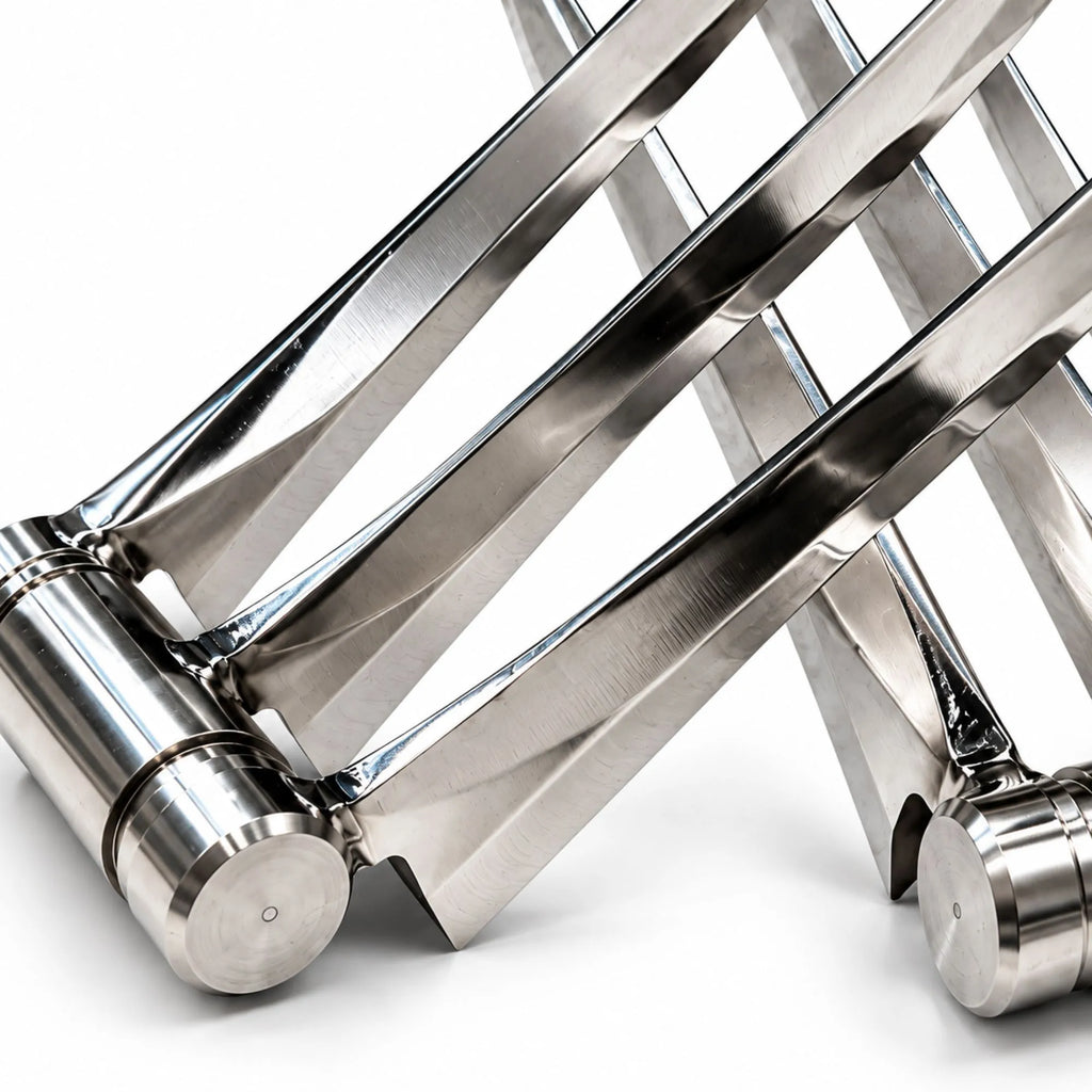 Close-up of a metallic folding table frame made of polished stainless steel, showing the joints and parallel legs on a white background.