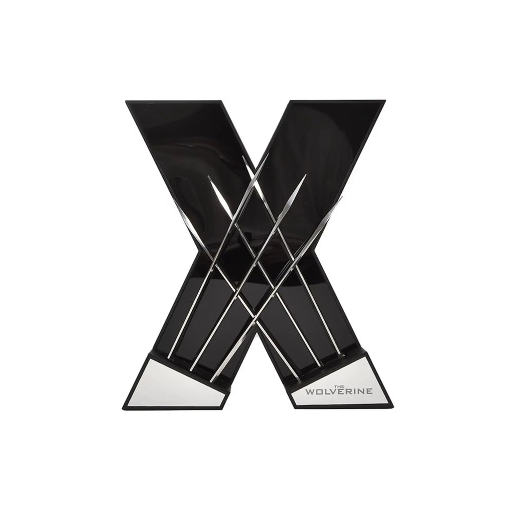 A glossy black letter X wall decor sculpture with metallic silver crossed elements and a silver base, featuring the word 'WOLVERINE' on the lower right, shown on a plain white background.